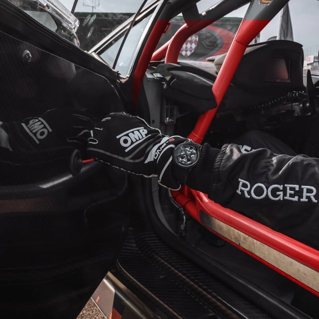 Driver closing a race car door wearing a Roger Dubuis watch