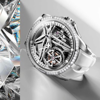 The image showcases the Roger Dubuis Excalibur Monotourbillon Watch RDDBEX0989, distinguished by its diamond-set case, white strap, and skeletonized dial that reveals a complex mechanical movement with a tourbillon. It is presented against an elegant background with sparkling crystal elements.