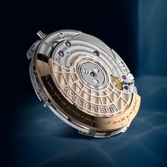 This image shows a detailed, close-up view of the Hommage la Placide timpiece mechanical watch movement. It features intricate silver and gold-toned components, gears, bridges, and visible jewels. The movement also includes fine engravings, notably a "ROGER DUBUIS" inscription and a handwritten French text, all set against a dark background.