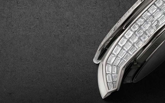 The image juxtaposes raw gemstones and a gem-set watch component, creating an interesting visual contrast that highlights the craftsmanship and precision required to create exceptional pieces.